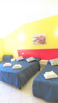 a room with two beds with towels on them at Fanti Rooms in Rome