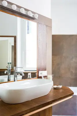 a bathroom with a large white tub and a mirror at The Royal Story in Rome