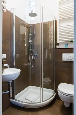 a bathroom with a shower with a sink and a toilet at The Royal Story in Rome