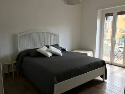 a bedroom with a black bed with two pillows at La casa di Alice in Rome