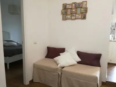 a living room with a couch and a bed at La casa di Alice in Rome