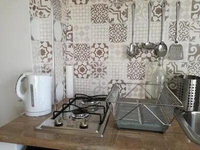 a kitchen counter with a stove and a sink at La casa di Alice in Rome