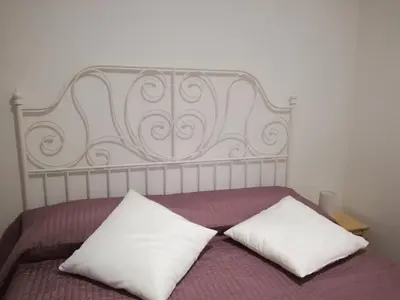 a bed with two white pillows on top of it at La casa di Alice in Rome