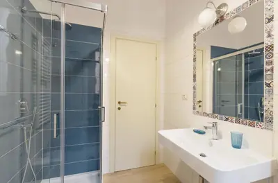 a bathroom with a sink and a shower at La Romàntìca al Colosseo in Rome