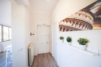 a hallway with a painting of the leaning tower at San Peter Raffy's House in Rome