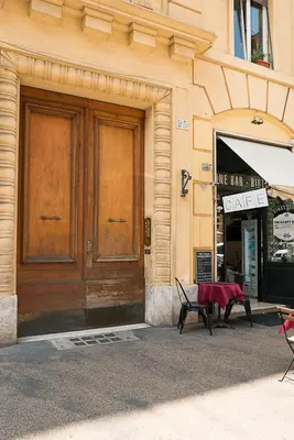 a building with a wooden door and a table outside at San Peter Raffy's House in Rome