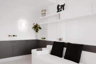 a living room with a white couch with black pillows at Lungotevere Suite in Rome
