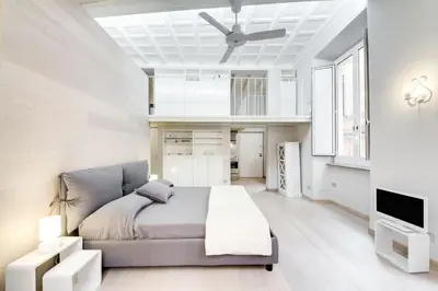 a bedroom with a bed and a ceiling fan at Appartamento vicolo della Vaccarella - Pantheon in Rome