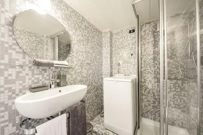 a bathroom with a sink and a shower and a mirror at Appartamento vicolo della Vaccarella - Pantheon in Rome