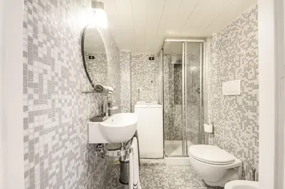 a bathroom with a sink and a toilet and a mirror at Appartamento vicolo della Vaccarella - Pantheon in Rome