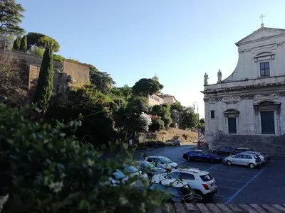 a group of cars parked in a parking lot next to a building at Foro Romano Luxury Suites in Rome