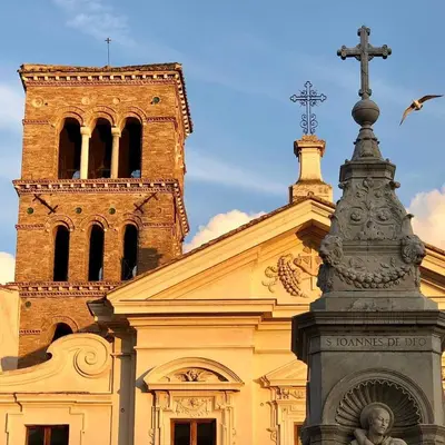 a church with a cross on top of it at Foro Romano Luxury Suites in Rome