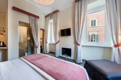 a bedroom with a bed and a window at Foro Romano Luxury Suites in Rome