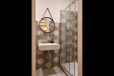 a bathroom with a sink and a mirror at Veneto Suite Rome in Rome
