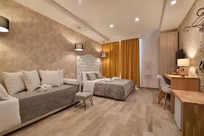 a hotel room with a bed and a couch at Veneto Suite Rome in Rome