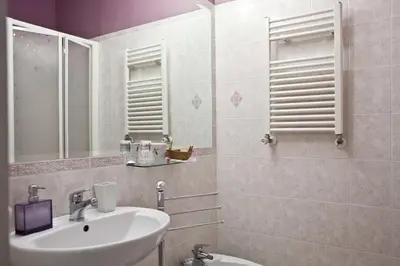 a bathroom with a sink and a mirror at Happy Stay Guesthouse in Rome
