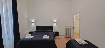 a bedroom with a bed with two slippers on it at Piumith Guest House in Rome