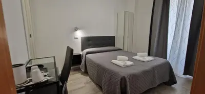 a bedroom with a bed with two towels on it at Piumith Guest House in Rome