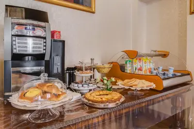 a counter with some pastries and other food on it at Affreschi Su Roma Luxury B&B in Rome