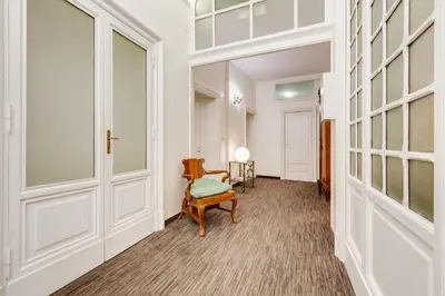 a hallway with a chair and a door at Affreschi Su Roma Luxury B&B in Rome