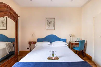a bedroom with a bed with a bottle of wine on it at Martina House in Rome