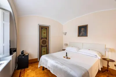 a bedroom with a large white bed in a room at Martina House in Rome