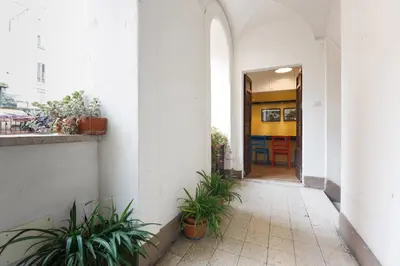 a hallway of a building with potted plants at Leutari Suite in Rome
