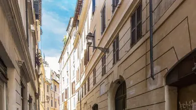 an alley in a city with tall buildings at Leutari Suite in Rome