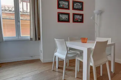 a dining room with a white table and chairs at La Casa Sui Fori in Rome