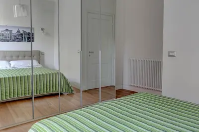 a bedroom with a bed and a mirror at La Casa Sui Fori in Rome