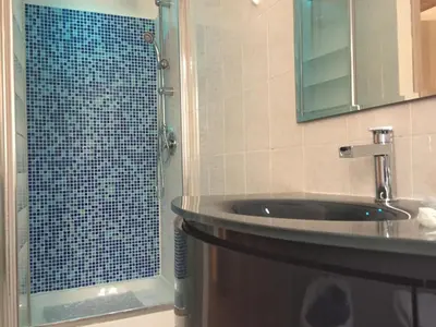 a bathroom with a sink and a glass shower at BenS'Houses - Villa Pamphili apartment in Rome