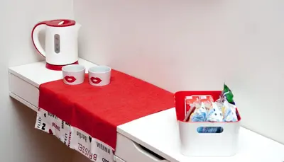 a table with two coffee cups and a box of chips at World Wide Bed - Prenestino in Rome