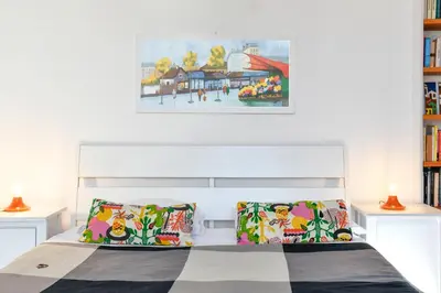 a bedroom with a bed with two pillows and a painting at Monti Deluxe - Terrace Spectacular View in Rome