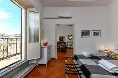 a bedroom with two beds and a large window at Monti Deluxe - Terrace Spectacular View in Rome