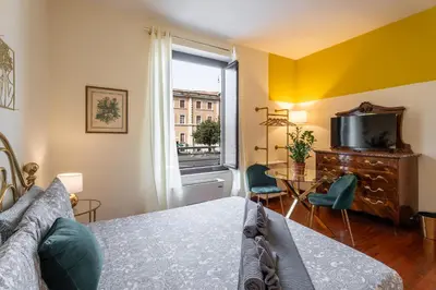 a bedroom with a bed and a television and a table at BigFamilyRome - Vatican & Navona in Rome