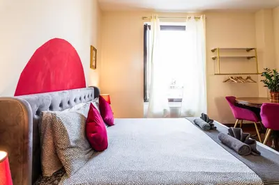a bedroom with a large bed with red pillows at BigFamilyRome - Vatican & Navona in Rome