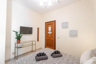 a living room with a couch and a television at BigFamilyRome - Vatican & Navona in Rome