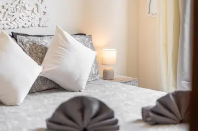 a bedroom with a bed with pillows and a lamp at BigFamilyRome - Vatican & Navona in Rome