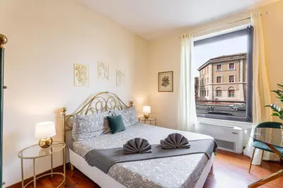 a bedroom with a bed and a large window at BigFamilyRome - Vatican & Navona in Rome