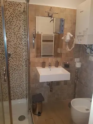 a bathroom with a sink and a shower at barberini holiday house in Rome