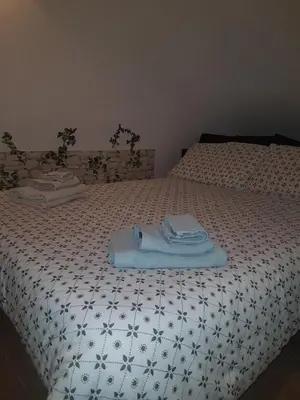 a bed with a blanket and towels on it at barberini holiday house in Rome