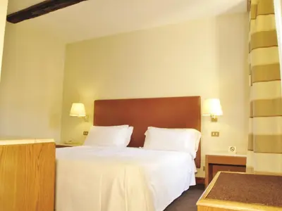 a hotel room with a bed and two lamps at Hotel Albergo Santa Chiara in Rome