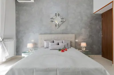 a bedroom with a large bed with red roses on it at Louise at Colosseum in Rome