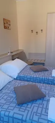 two beds in a room with blue and white at Vatican View Rooms in Rome