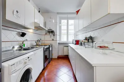 a white kitchen with a sink and a dishwasher at BigFamilyRome - Spanish Steps in Rome