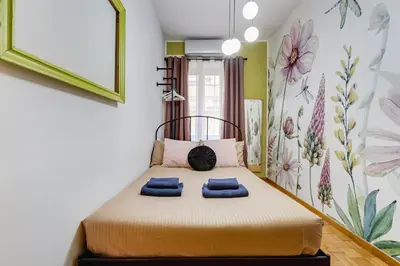 a bedroom with a bed with two blue towels on it at BigFamilyRome - Spanish Steps in Rome