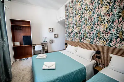 a hotel room with a bed with two white napkins at Hotel Dell'Urbe in Rome