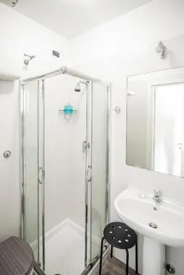 a bathroom with a glass shower and a sink at Hotel Dell'Urbe in Rome