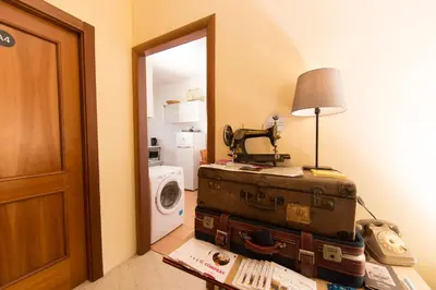a room with an open door with a suitcase and a camera at BigFamilyRome - Sistine Chapel in Rome