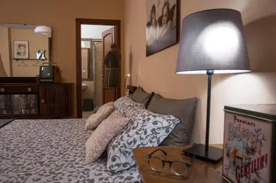 a bedroom with a bed with pillows and a lamp at BigFamilyRome - Sistine Chapel in Rome